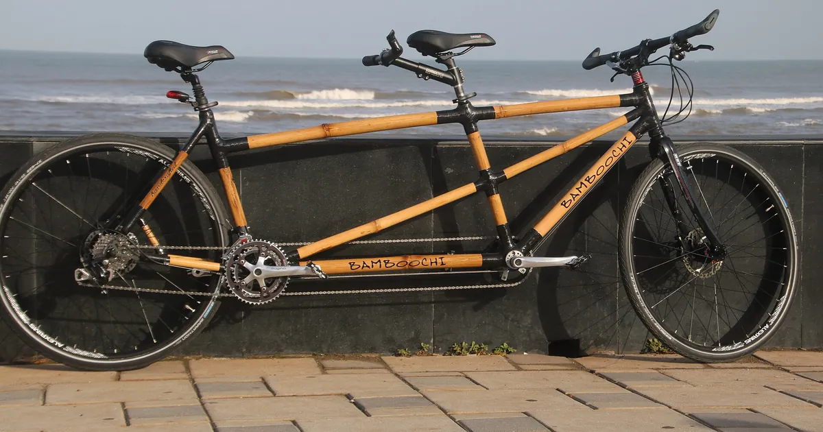 Tandem bicycle along a quay